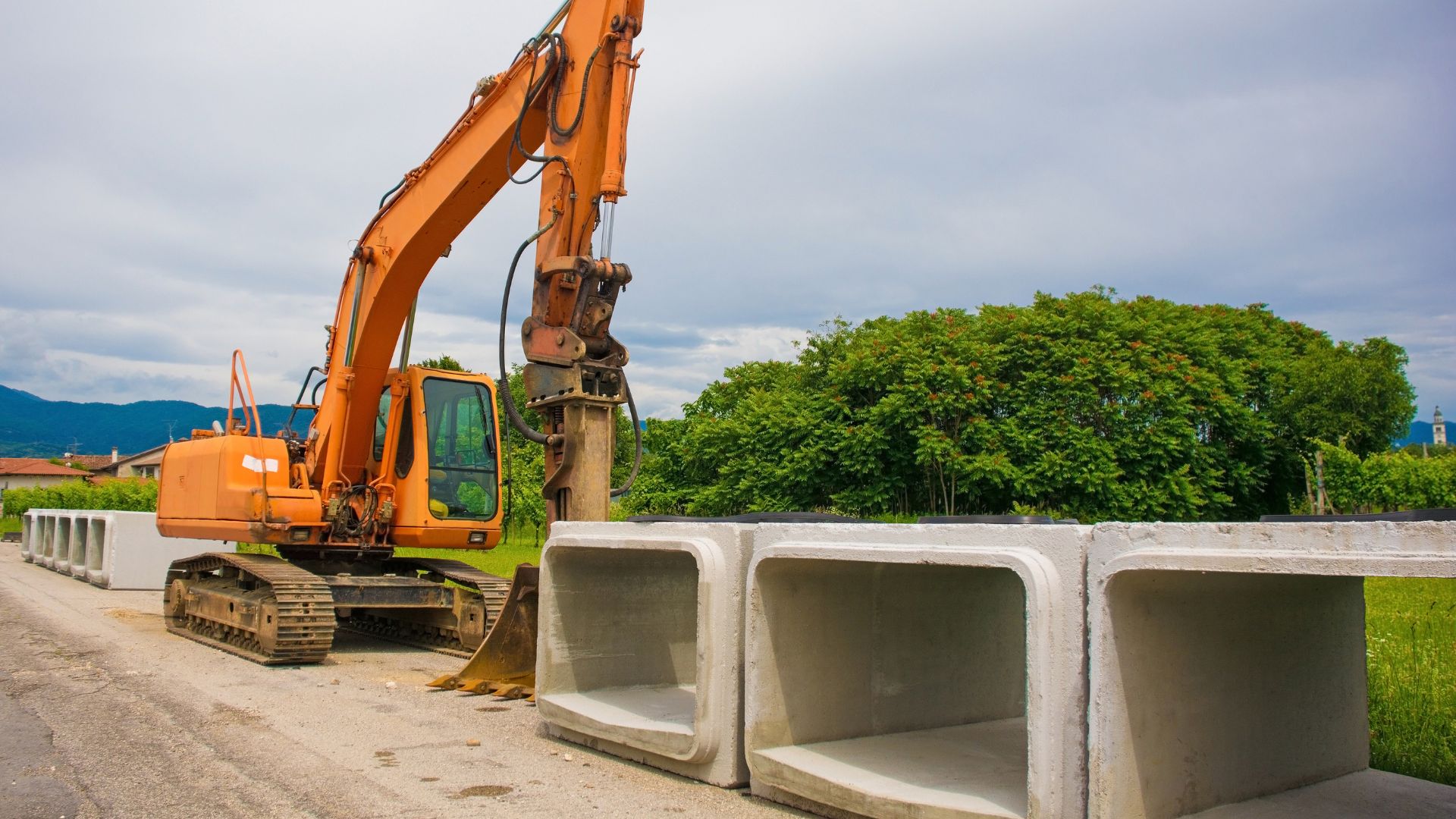 A construction vehicle is parked next to cinder blocks