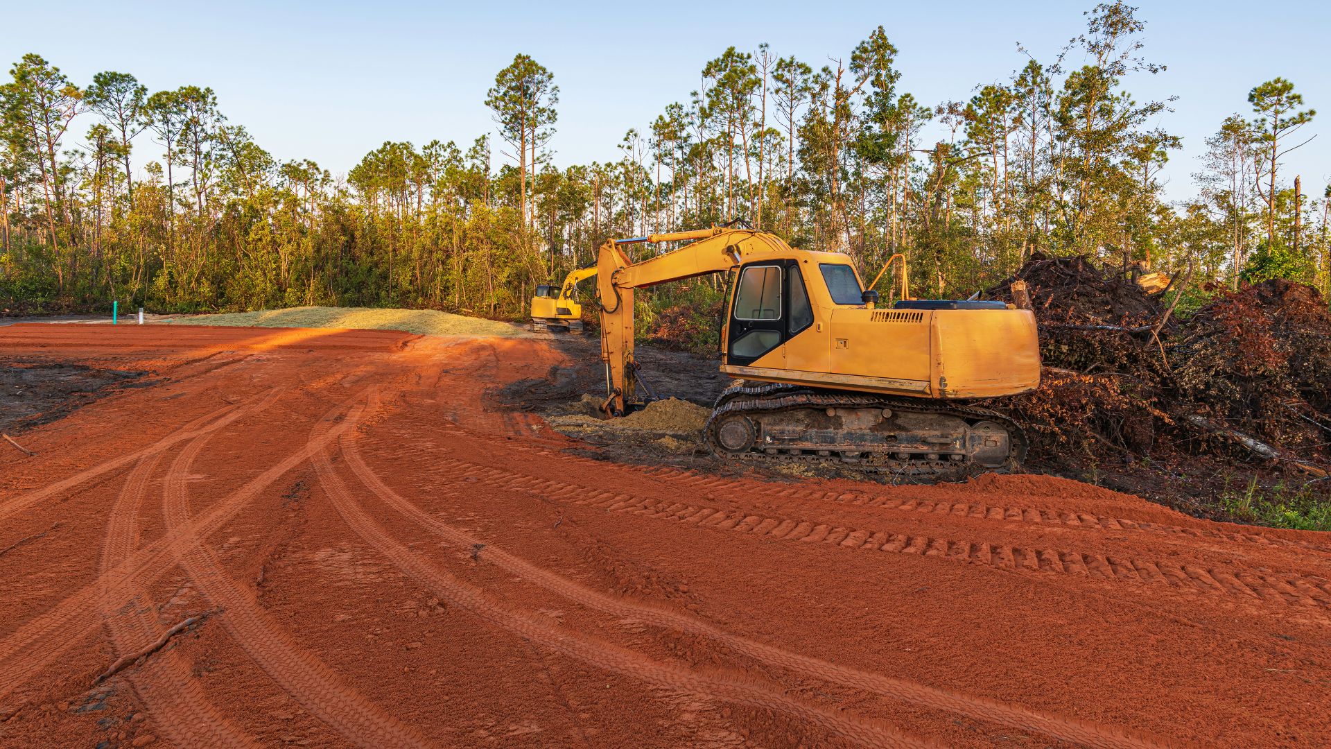 A bulldozer digging dirt on a dirt road